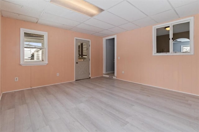 spare room featuring a paneled ceiling and wood finished floors