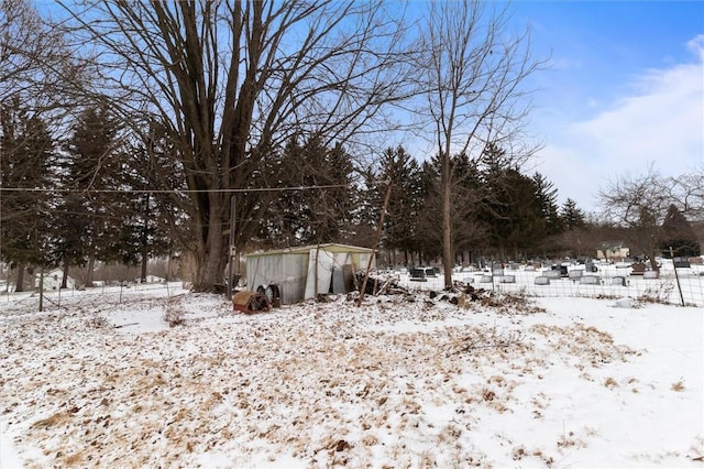 snowy yard with an outbuilding