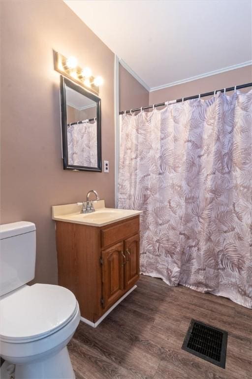 full bathroom featuring toilet, visible vents, wood finished floors, and vanity