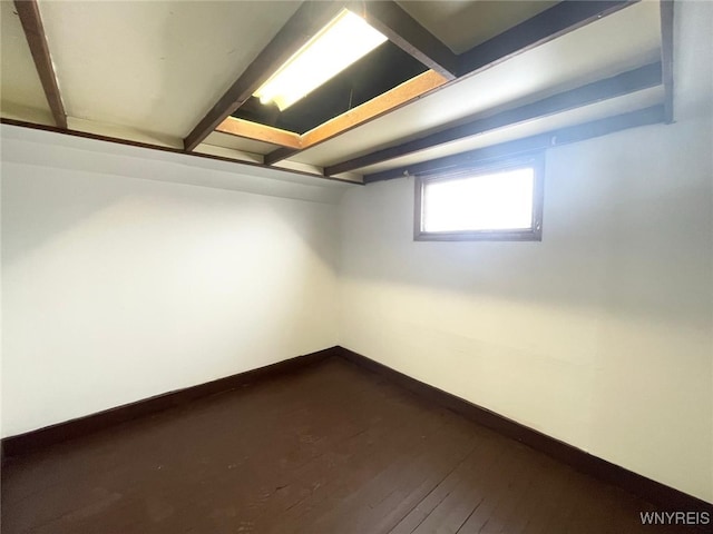 basement with dark wood-style floors and baseboards