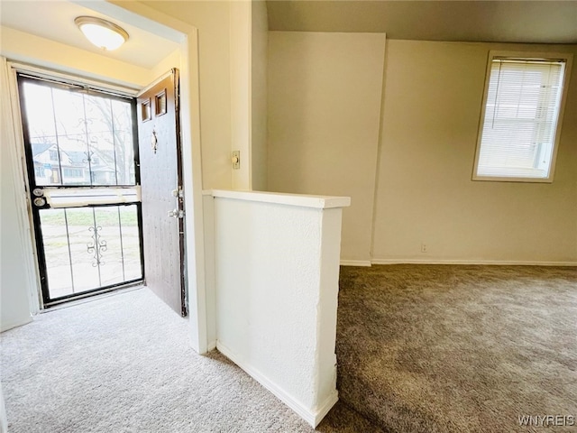 carpeted entryway with baseboards