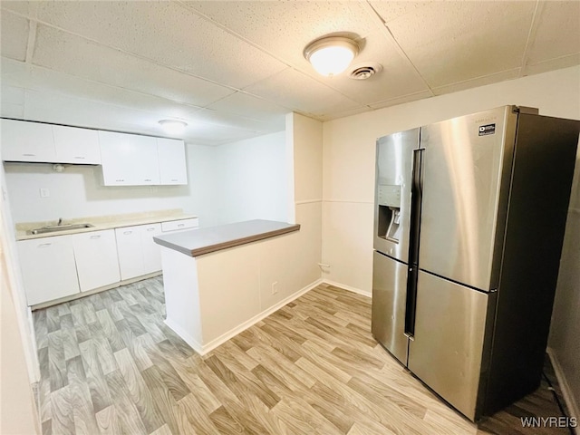 190 Davidson Ave, Buffalo, NY 14215 - kitchen with a peninsula, stainless steel refrigerator with ice dispenser, visible vents, and light wood-style floors