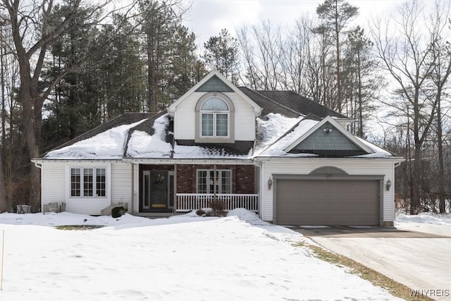 view of front of property with a garage, covered porch, and driveway