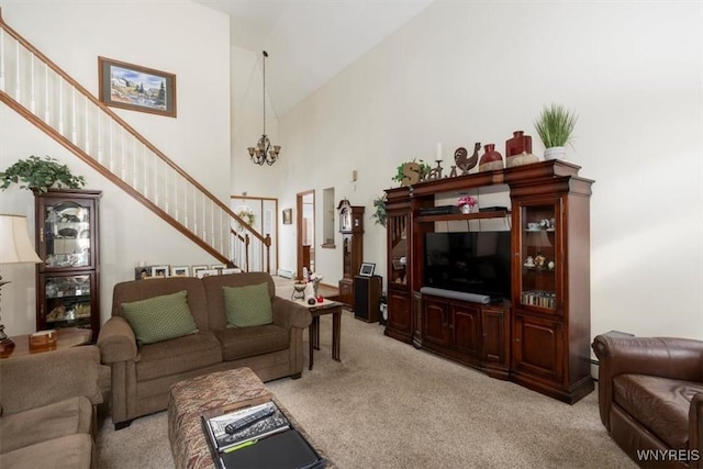 living room with high vaulted ceiling, light colored carpet, a notable chandelier, and stairway