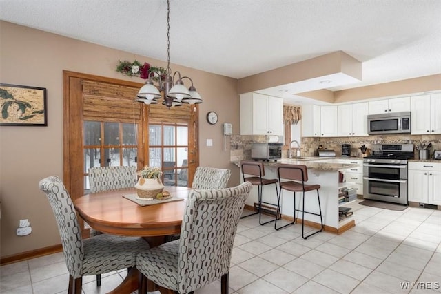 dining area with baseboards, light tile patterned flooring, and an inviting chandelier