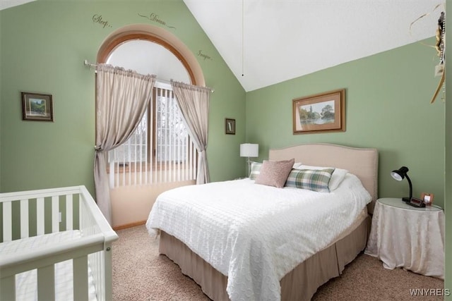 bedroom with light carpet and vaulted ceiling