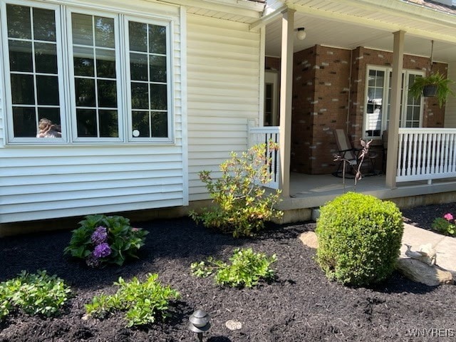 view of side of property featuring covered porch