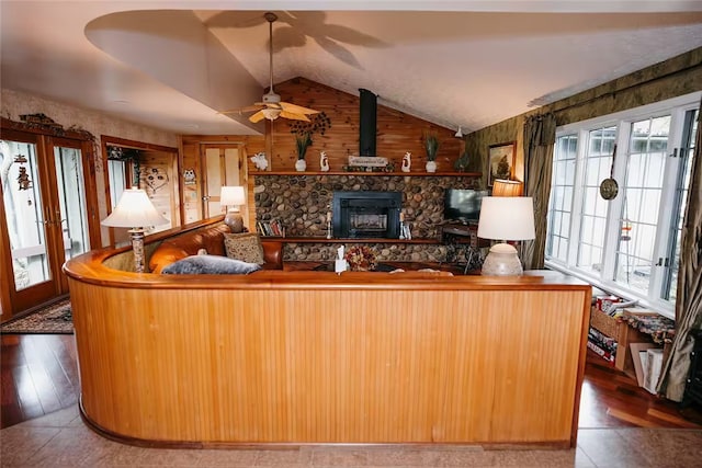 living area with lofted ceiling, french doors, and tile patterned flooring