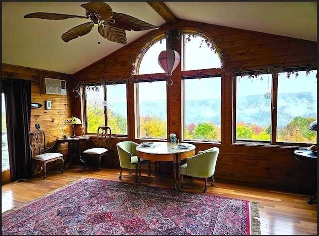 sunroom / solarium featuring vaulted ceiling with beams and ceiling fan