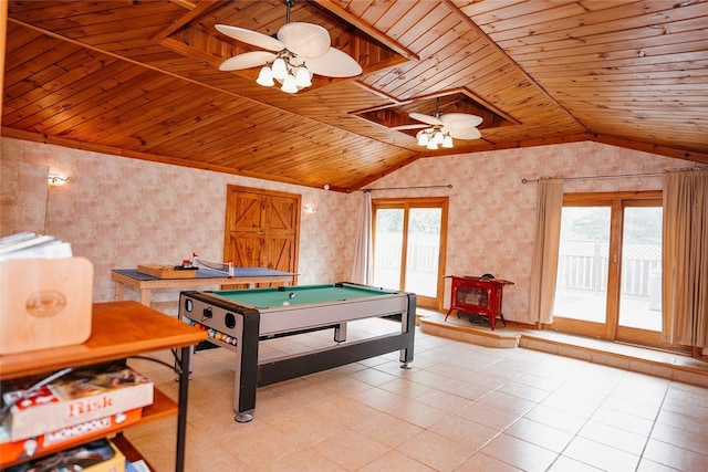 game room with vaulted ceiling, a wood stove, wooden ceiling, and ceiling fan