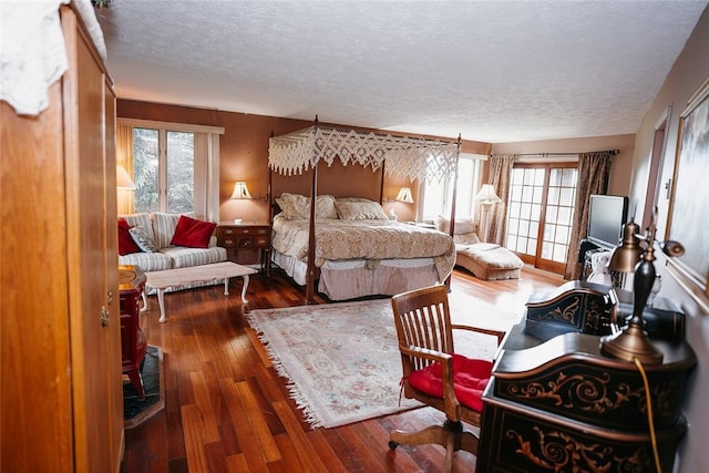 bedroom featuring a textured ceiling and hardwood / wood-style flooring