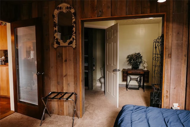 bedroom with wood walls and carpet