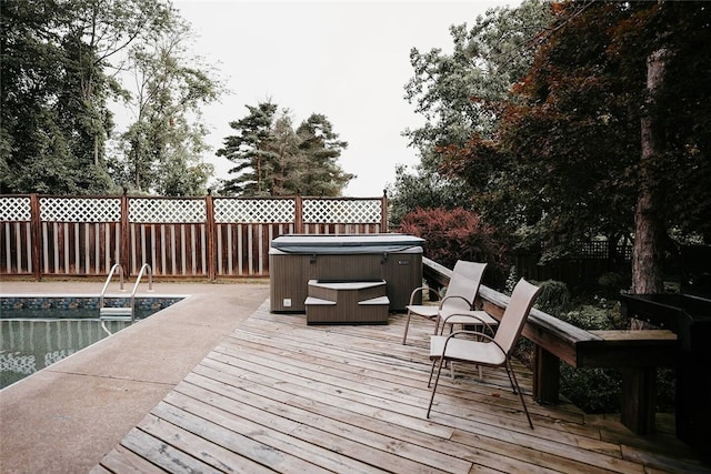 deck featuring a fenced in pool, fence, and a hot tub