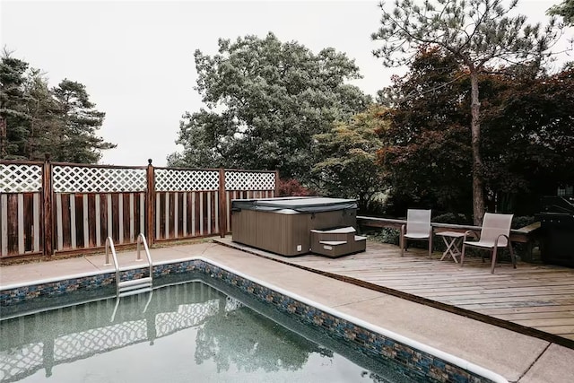 view of swimming pool featuring a fenced in pool, fence, a hot tub, and a wooden deck