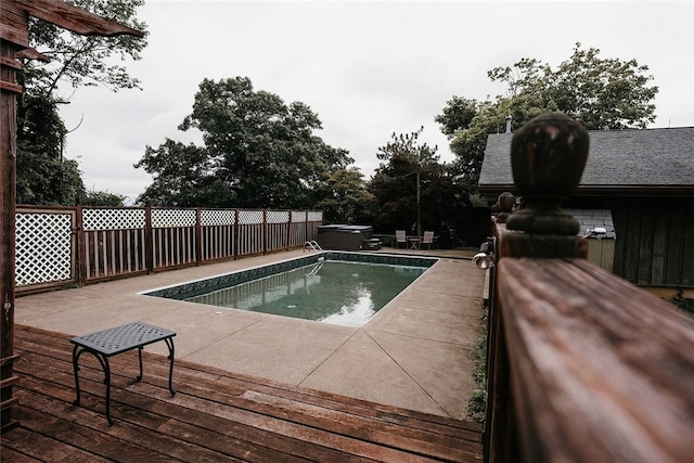 view of swimming pool with an outdoor hot tub and a deck