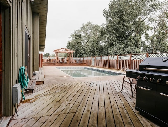 deck featuring a gazebo, grilling area, and fence