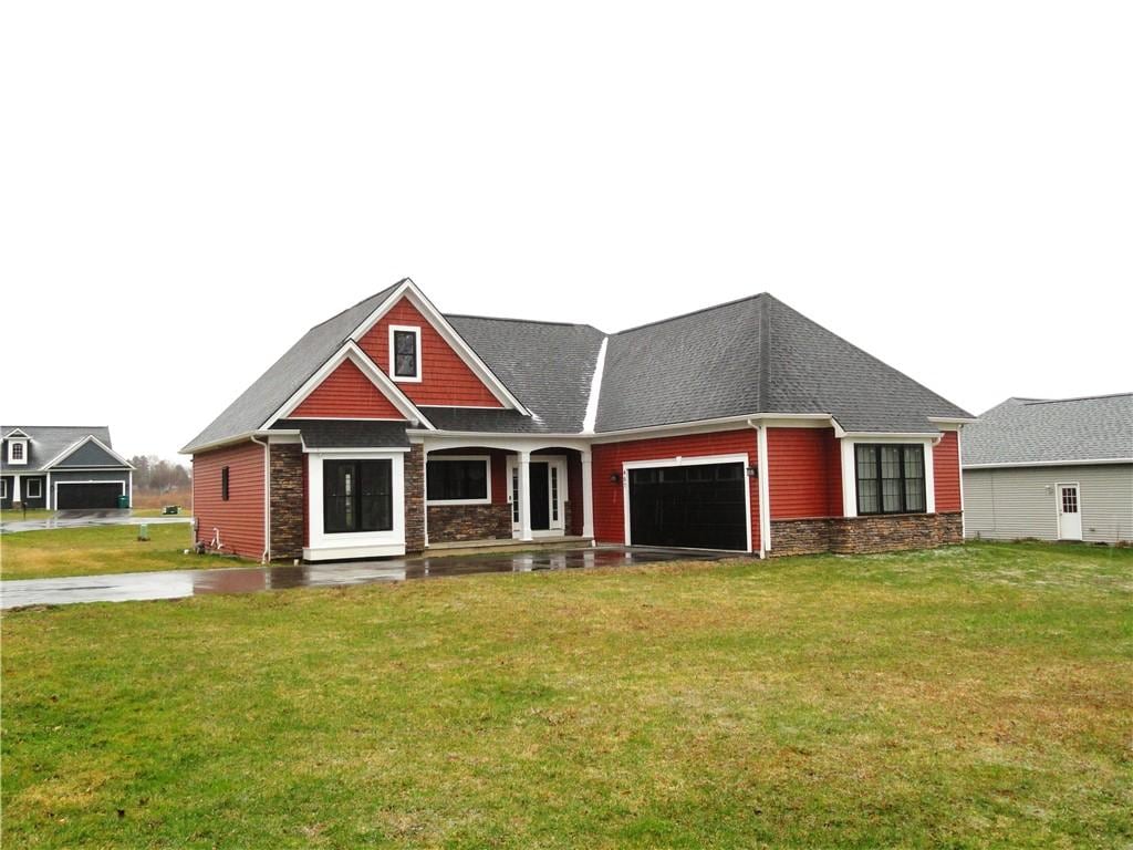 467 Pardee Rd, Irondequoit, NY 14609 - craftsman inspired home featuring stone siding, a garage, and a front lawn