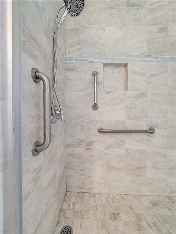 bathroom with tiled shower