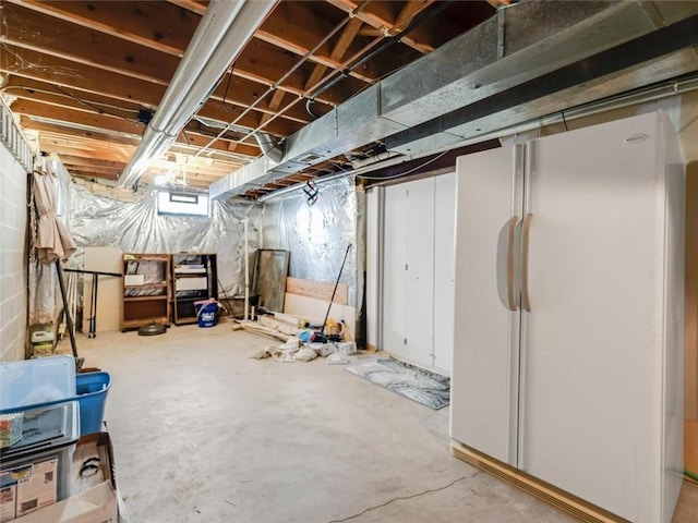 basement featuring freestanding refrigerator