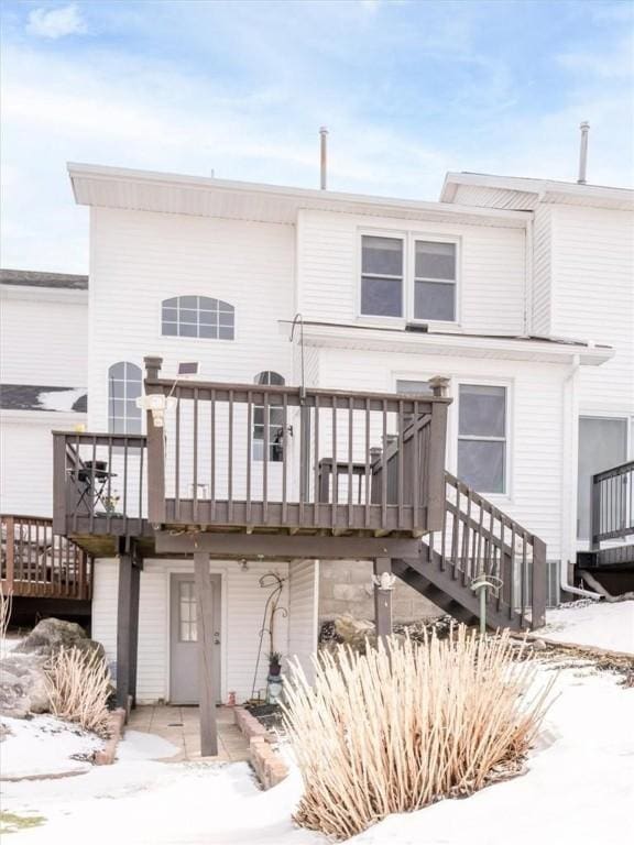 rear view of house featuring a wooden deck