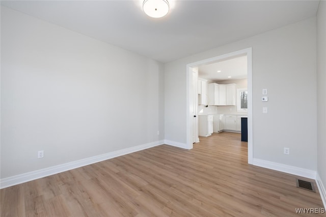 unfurnished living room with recessed lighting, visible vents, light wood finished floors, and baseboards