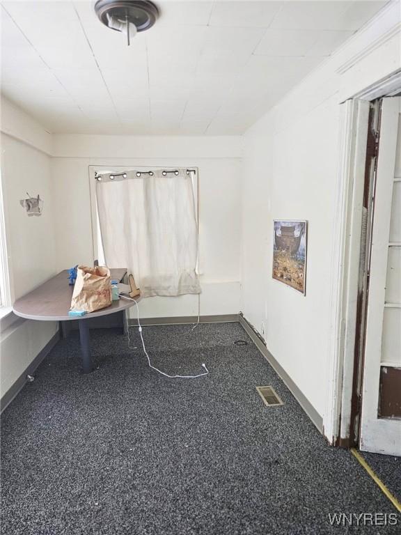 unfurnished dining area featuring visible vents and baseboards