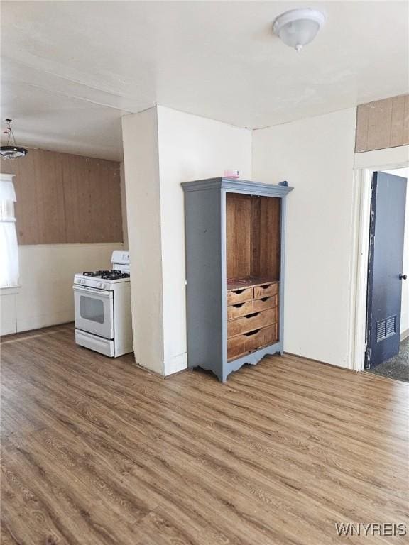 kitchen featuring white gas range oven, visible vents, and wood finished floors