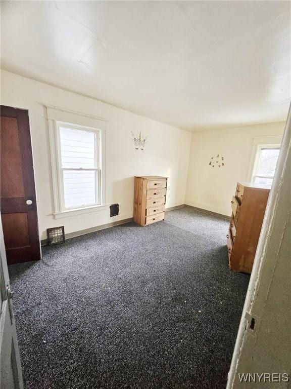 spare room with baseboards