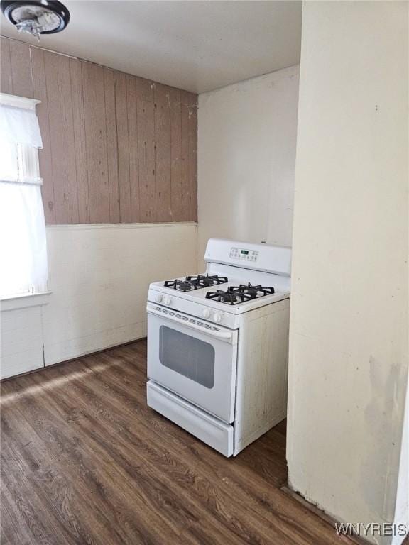 kitchen with dark wood finished floors and white gas stove