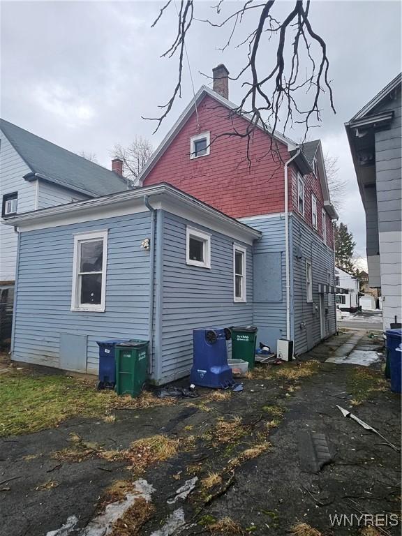 back of property featuring a chimney