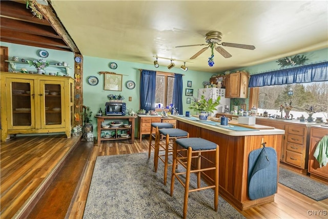 225 Amberg Rd, Ohio, NY 13324 - kitchen featuring freestanding refrigerator, a center island, ceiling fan, light countertops, and brown cabinetry