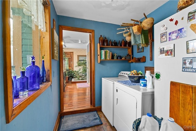 clothes washing area featuring laundry area, independent washer and dryer, and baseboards