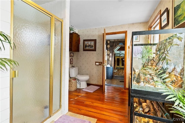 225 Amberg Rd, Ohio, NY 13324 - bathroom featuring wood-type flooring, toilet, a stall shower, and wallpapered walls