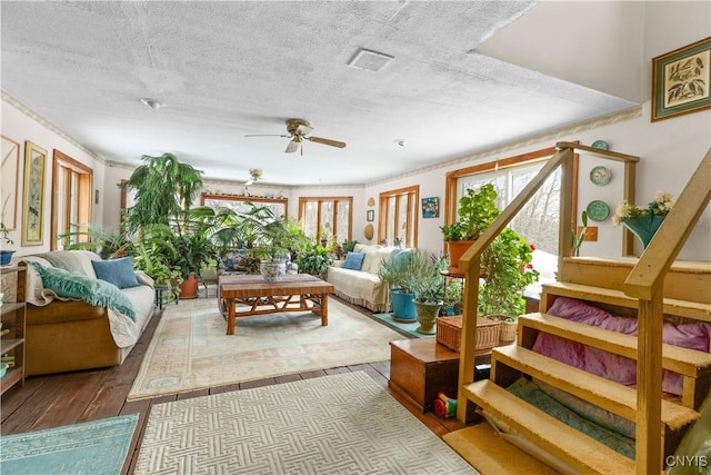 225 Amberg Rd, Ohio, NY 13324 - living room featuring healthy amount of natural light, hardwood / wood-style floors, a ceiling fan, a textured ceiling, and stairs
