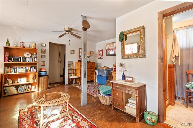 sitting room featuring a ceiling fan