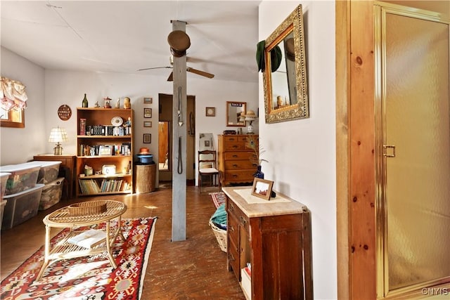 interior space with ceiling fan