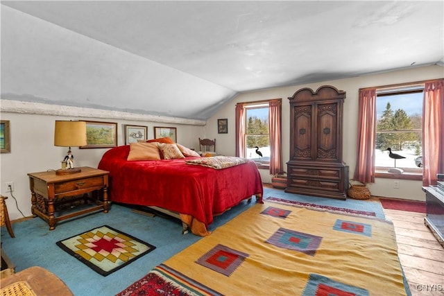 carpeted bedroom featuring vaulted ceiling