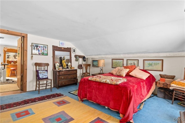 bedroom featuring carpet floors and vaulted ceiling