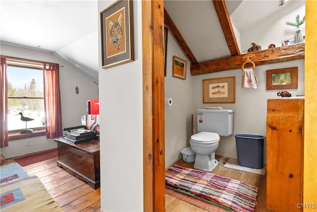 bathroom with lofted ceiling with beams, hardwood / wood-style floors, and toilet