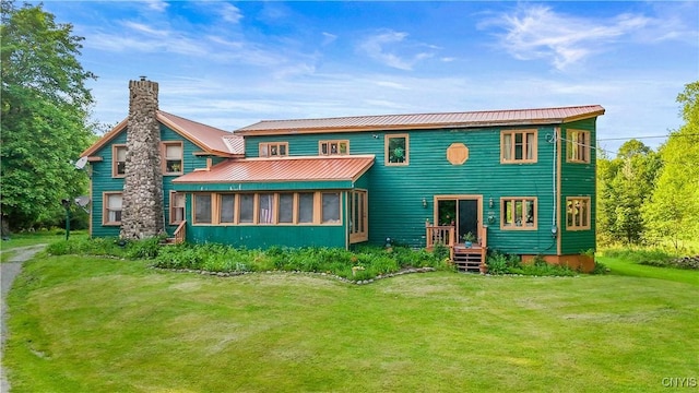 225 Amberg Rd, Ohio, NY 13324 - back of house featuring a chimney, a sunroom, a lawn, and metal roof