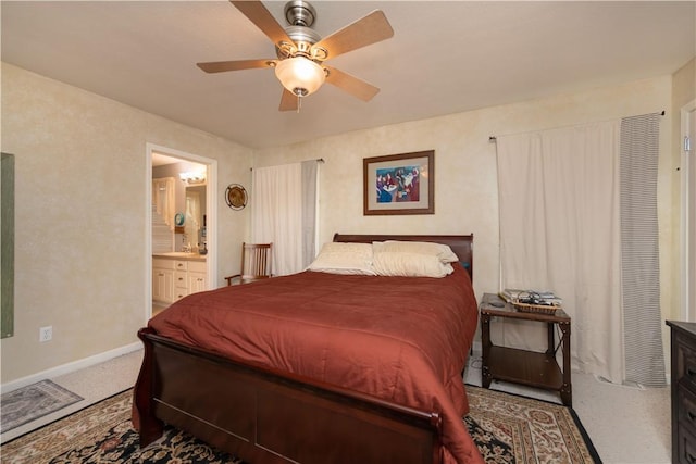 carpeted bedroom with baseboards, ceiling fan, visible vents, and ensuite bath