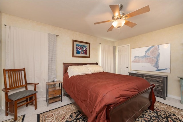 bedroom featuring a ceiling fan and light colored carpet