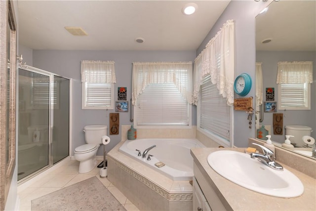 bathroom with a garden tub, toilet, a stall shower, vanity, and tile patterned flooring