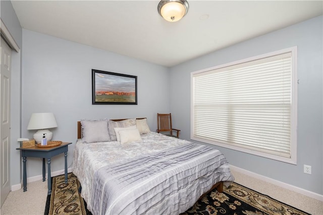 bedroom featuring carpet floors, baseboards, and a closet