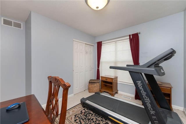 workout room with carpet, visible vents, and baseboards