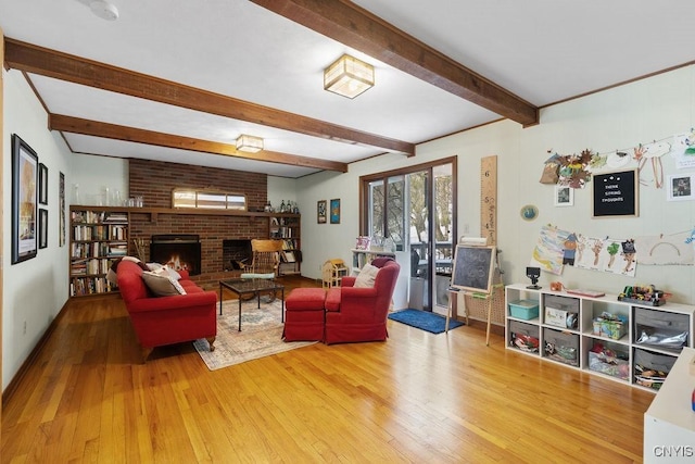 living room with a brick fireplace, wood-type flooring, and beam ceiling