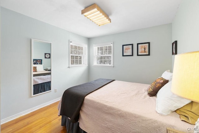 bedroom with baseboards and wood finished floors