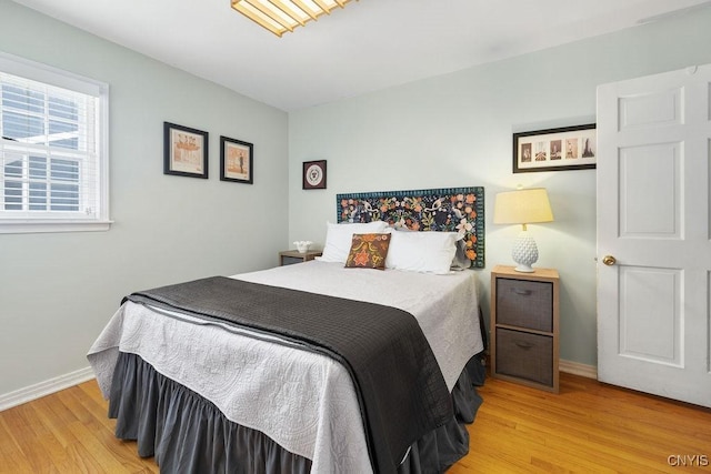 bedroom featuring light wood-style flooring and baseboards