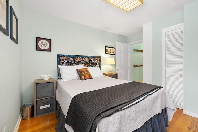 bedroom featuring baseboards and wood finished floors