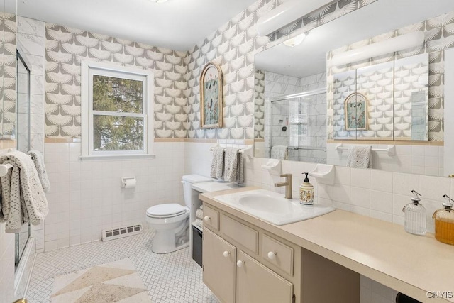 bathroom featuring visible vents, toilet, tile patterned floors, a shower stall, and tile walls